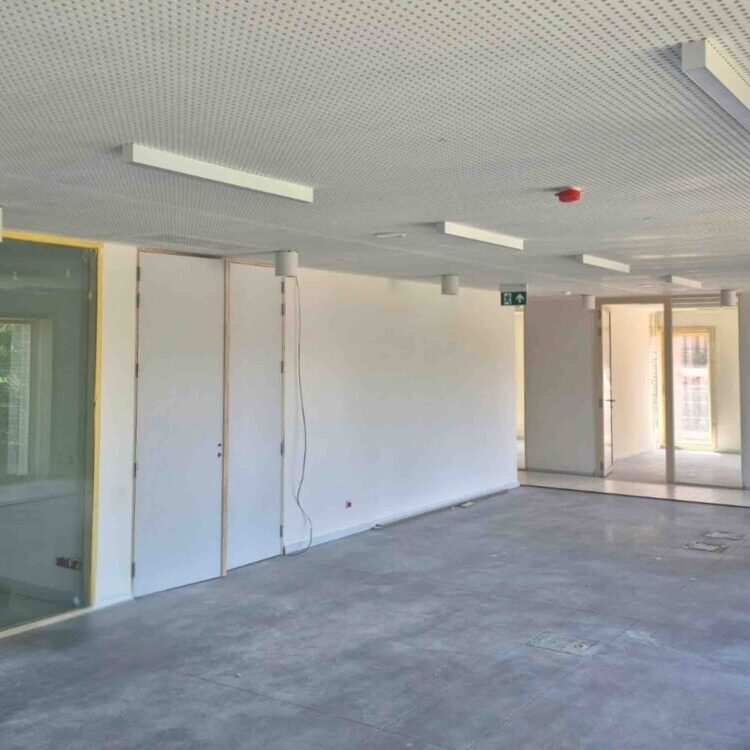 Installation de lampes au plafond d'une future salle de réunion de l'Hôtel de Ville de Hannut